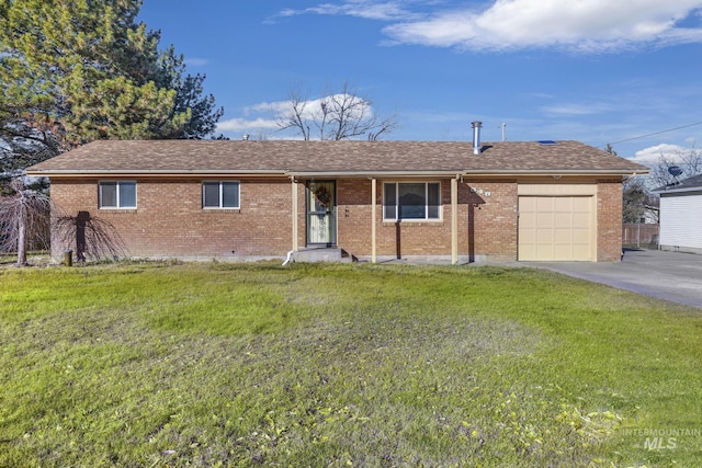 ranch-style house featuring a front yard and a garage