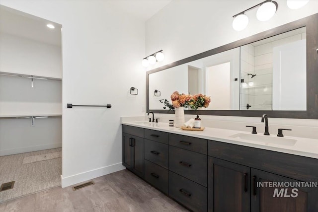 2391 E Snocreek Dr, Eagle, ID 83616 - full bathroom with baseboards, a sink, a tile shower, and double vanity