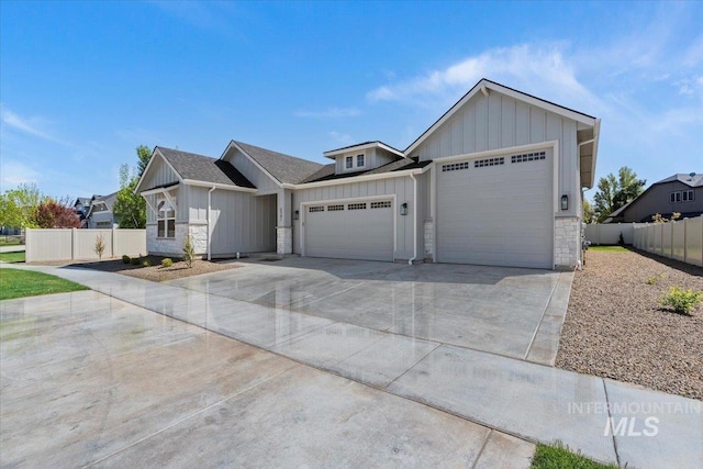 2391 E Snocreek Dr, Eagle, ID 83616 - view of front of property with a garage, board and batten siding, driveway, and stone siding