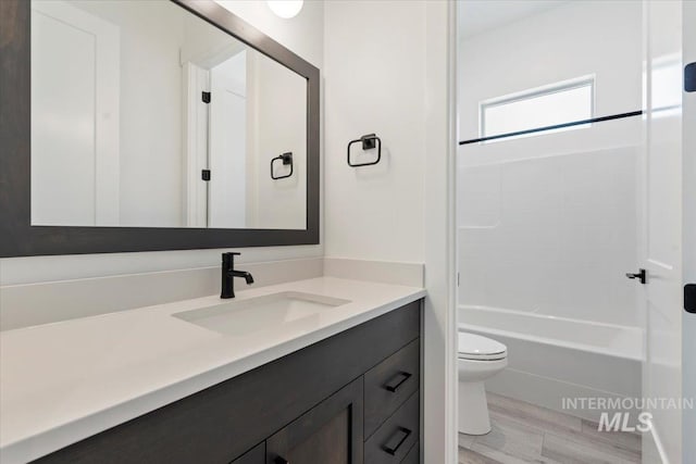 2391 E Snocreek Dr, Eagle, ID 83616 - full bath featuring toilet, bathing tub / shower combination, wood finished floors, and vanity