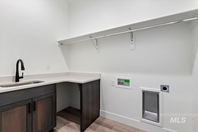 2391 E Snocreek Dr, Eagle, ID 83616 - washroom featuring light wood-type flooring, cabinet space, a sink, washer hookup, and hookup for an electric dryer