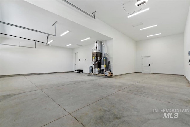 2391 E Snocreek Dr, Eagle, ID 83616 - garage with baseboards, a garage door opener, and gas water heater