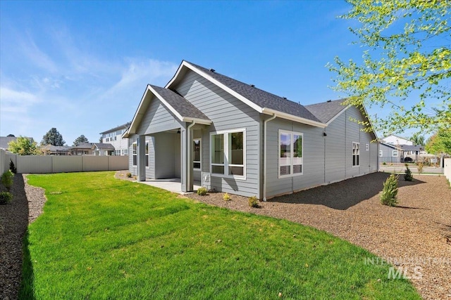 2391 E Snocreek Dr, Eagle, ID 83616 - back of house with a fenced backyard, a yard, a patio area, and roof with shingles