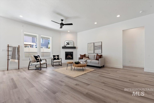 2391 E Snocreek Dr, Eagle, ID 83616 - living area featuring a ceiling fan, a large fireplace, baseboards, light wood finished floors, and recessed lighting