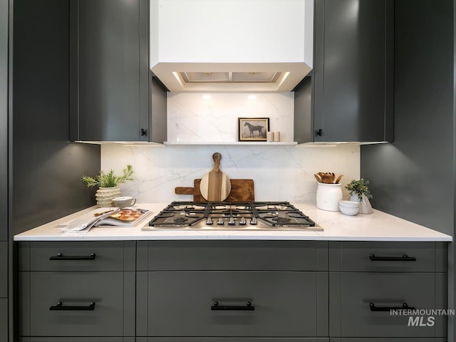 6241 W Strant St, Eagle, ID 83616 - kitchen featuring gray cabinets, stainless steel gas stovetop, backsplash, and custom range hood