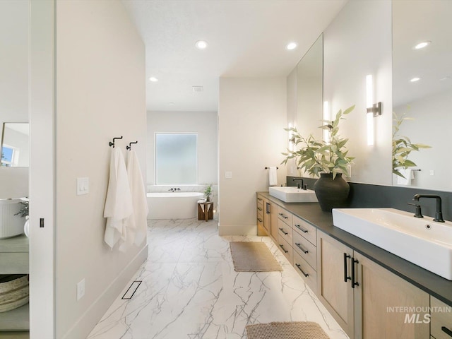 6241 W Strant St, Eagle, ID 83616 - full bath with double vanity, a freestanding bath, recessed lighting, baseboards, and marble finish floors