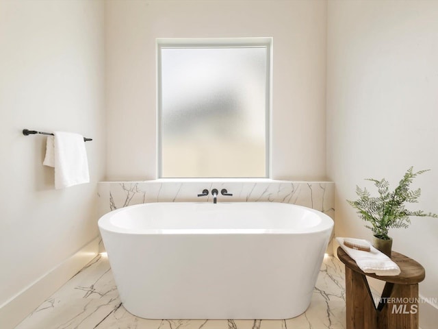 6241 W Strant St, Eagle, ID 83616 - full bathroom featuring marble finish floors, a freestanding tub, and baseboards
