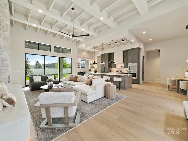 6241 W Strant St, Eagle, ID 83616 - living area with light wood-type flooring, beamed ceiling, a towering ceiling, recessed lighting, and a ceiling fan