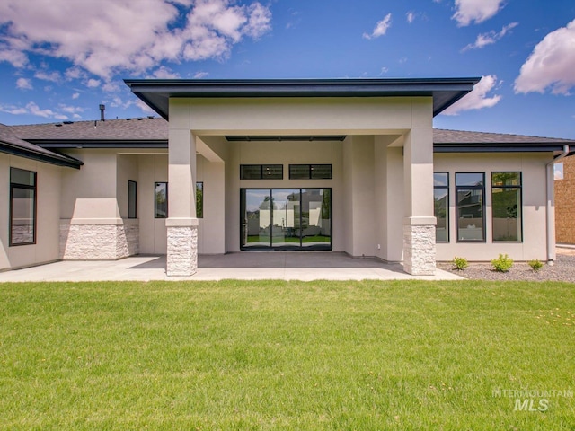 6241 W Strant St, Eagle, ID 83616 - rear view of house featuring stucco siding, a patio, stone siding, and a lawn