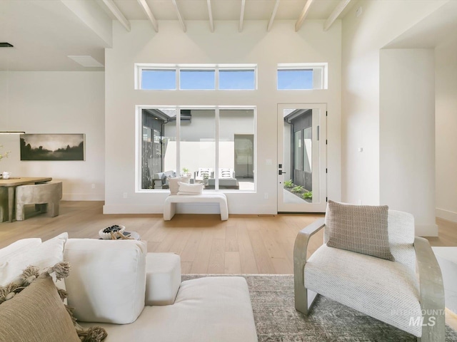 6241 W Strant St, Eagle, ID 83616 - living room featuring beam ceiling, wood finished floors, and a high ceiling