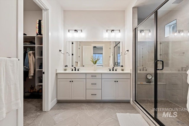 bathroom with vanity and a shower with shower door