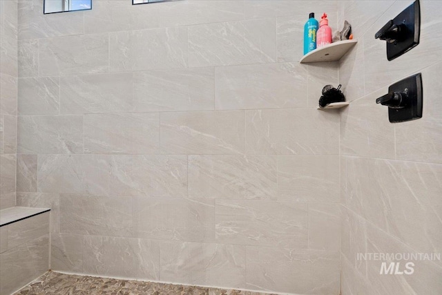 bathroom with a tile shower