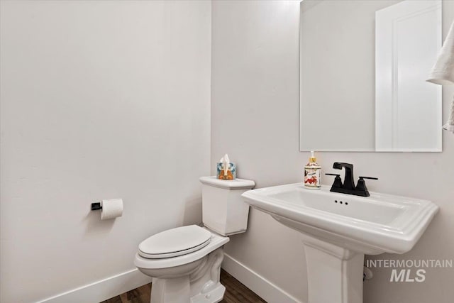 bathroom featuring hardwood / wood-style floors and toilet