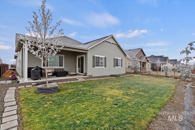 rear view of property with a patio area, a yard, and an outdoor hangout area