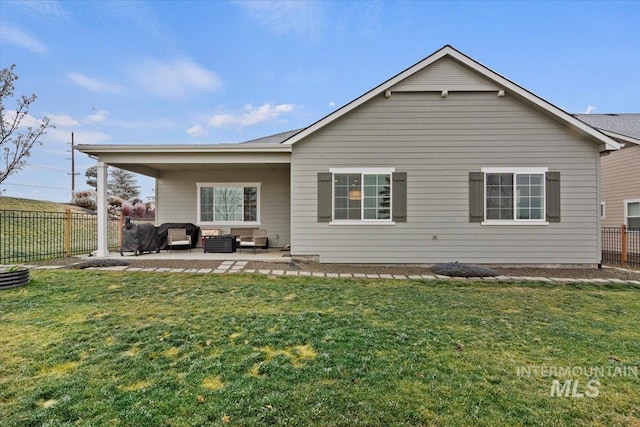 back of property with a lawn, a patio, and an outdoor hangout area