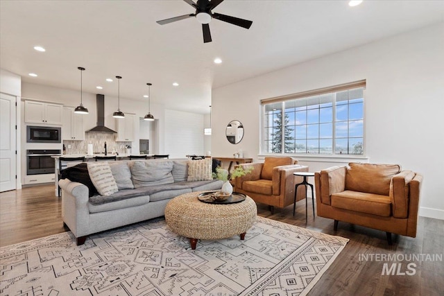 living room featuring ceiling fan and light hardwood / wood-style flooring