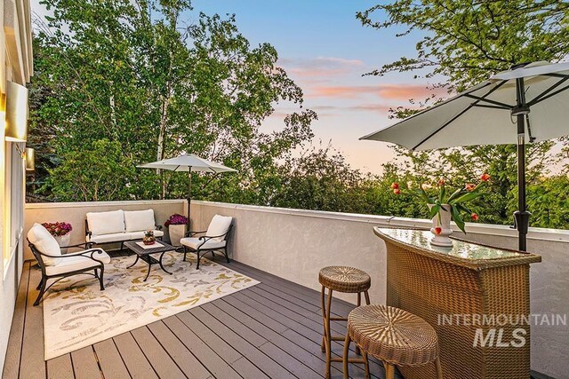 wooden terrace featuring an outdoor hangout area