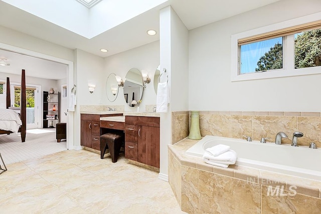 2196 E Ridgecrest Dr, Boise, ID 83712 - bathroom featuring a bath, ensuite bathroom, vanity, recessed lighting, and a skylight
