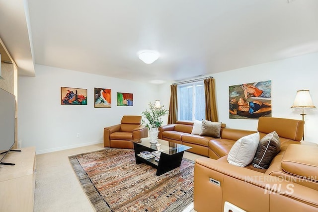 living room featuring light carpet and baseboards
