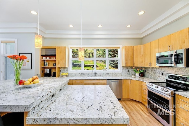 kitchen featuring stainless steel appliances, a sink, light stone counters, tasteful backsplash, and recessed lighting