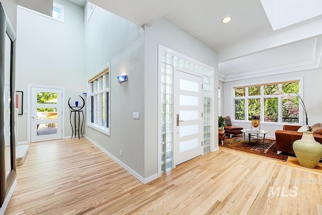 foyer entrance with light wood-type flooring, baseboards, and recessed lighting