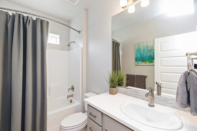 bathroom featuring shower / tub combo, vanity, and toilet