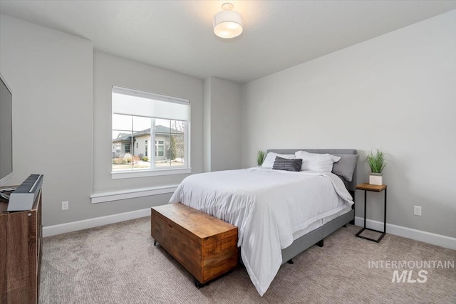 carpeted bedroom featuring baseboards