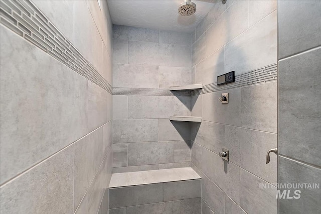 bathroom with tiled shower