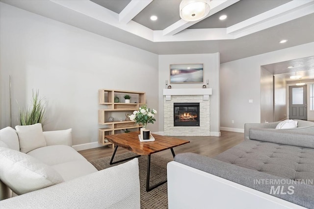 living area featuring recessed lighting, beamed ceiling, baseboards, and wood finished floors