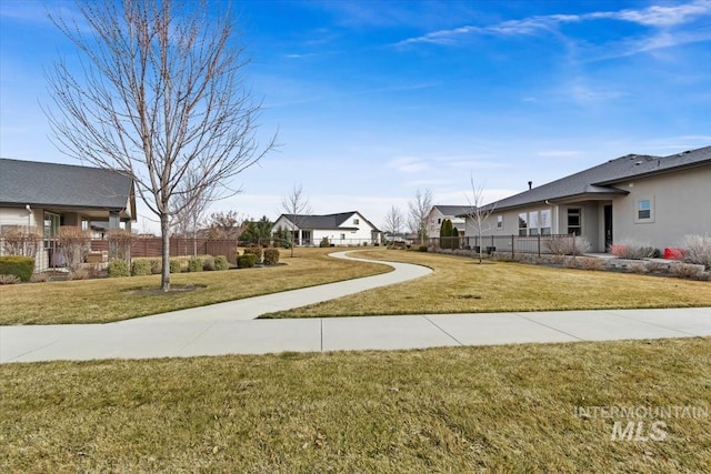 view of yard with fence and a residential view