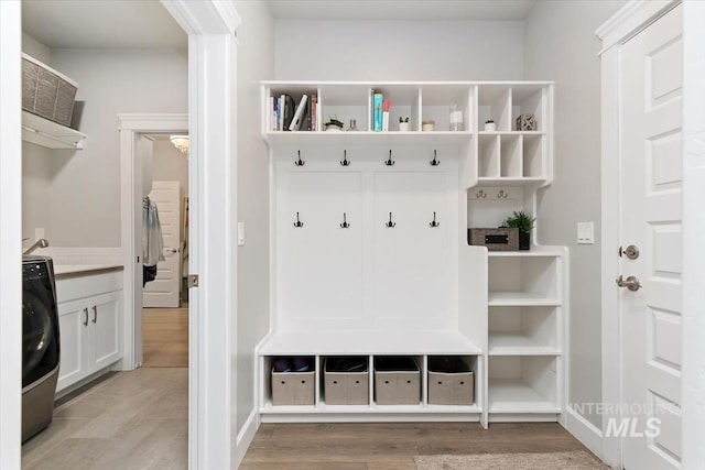 mudroom featuring light wood-type flooring and washer / clothes dryer