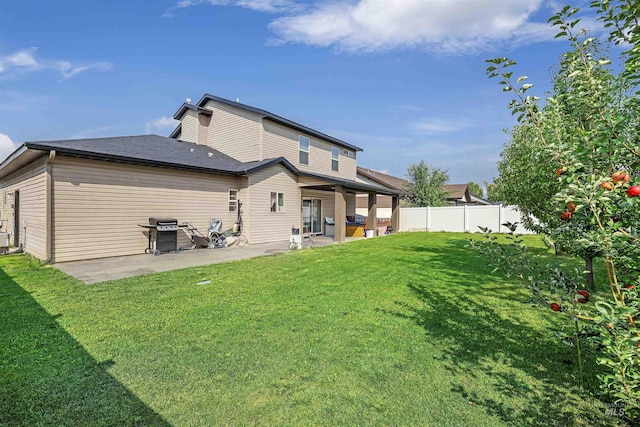 back of house featuring central air condition unit, fence, a patio, and a yard