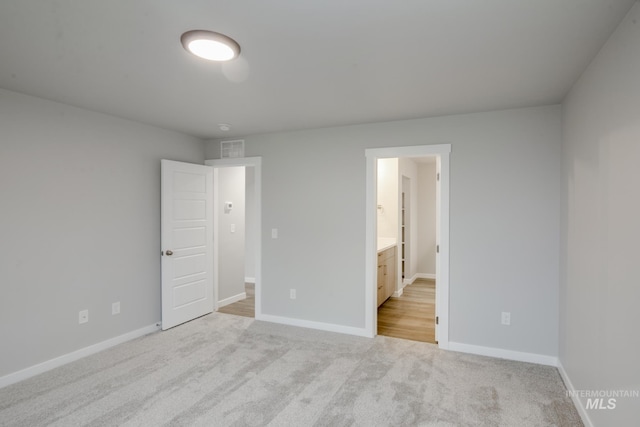 unfurnished bedroom with carpet floors, visible vents, and baseboards