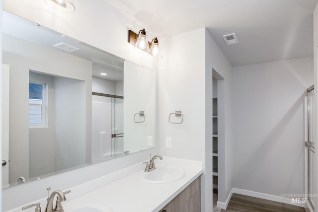 bathroom featuring double vanity, visible vents, and a sink