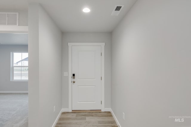 doorway with visible vents and baseboards