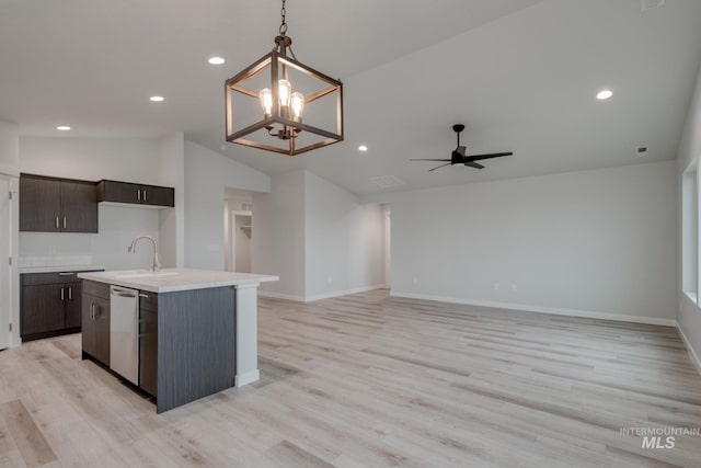 3503 W Morere Dr, Meridian, ID 83642 - kitchen with dishwasher, a sink, light countertops, dark brown cabinetry, and lofted ceiling