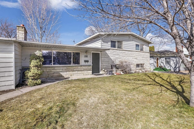 151 Fillmore St, Twin Falls, ID 83301 - view of front facade featuring a front yard, stone siding, and a chimney