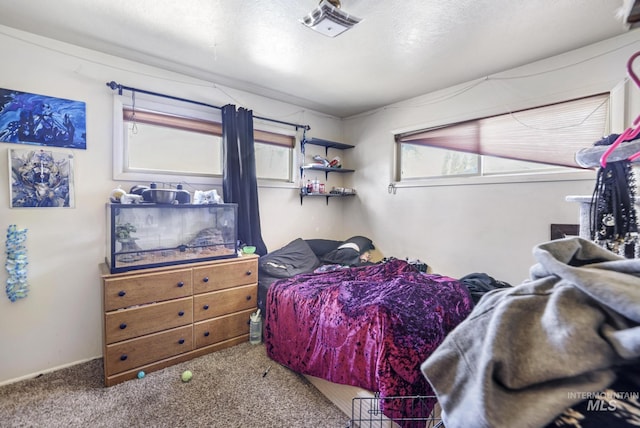 carpeted bedroom with a textured ceiling