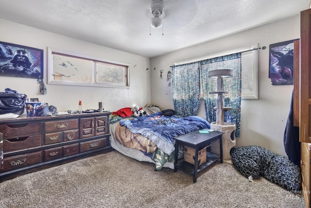 bedroom with carpet floors, a textured ceiling, and a ceiling fan