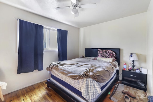 bedroom with hardwood / wood-style flooring and a ceiling fan