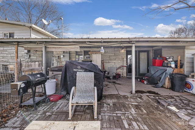 wooden terrace featuring a patio and a grill