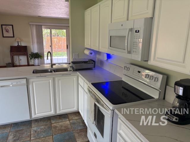 3707 N Jullion Way, Boise, ID 83704 - kitchen featuring white appliances, a sink, white cabinetry, and light countertops