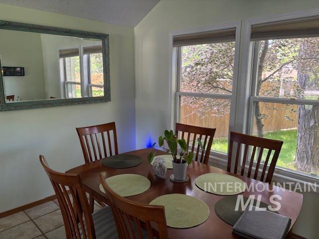 3707 N Jullion Way, Boise, ID 83704 - tiled dining area with vaulted ceiling, plenty of natural light, and baseboards