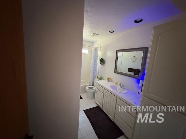 3707 N Jullion Way, Boise, ID 83704 - bathroom featuring vanity, toilet, shower / bath combo with shower curtain, tile patterned floors, and a textured ceiling