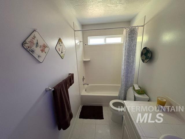 3707 N Jullion Way, Boise, ID 83704 - bathroom with toilet, a textured ceiling, tile patterned flooring, shower / bath combination with curtain, and vanity