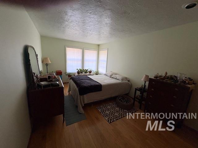 3707 N Jullion Way, Boise, ID 83704 - bedroom with wood finished floors and a textured ceiling