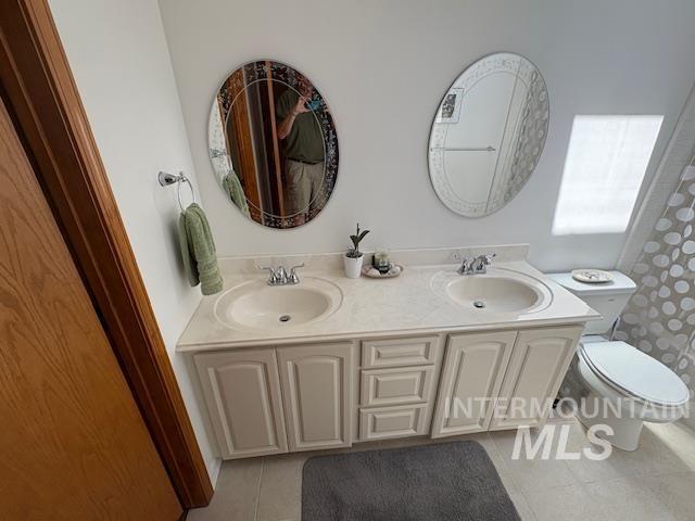 3707 N Jullion Way, Boise, ID 83704 - bathroom featuring tile patterned floors, double vanity, and toilet