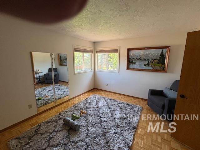 3707 N Jullion Way, Boise, ID 83704 - sitting room with a textured ceiling and baseboards
