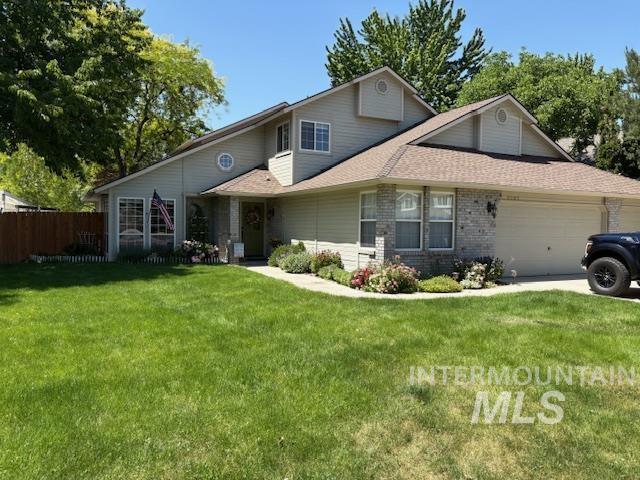 3707 N Jullion Way, Boise, ID 83704 - traditional-style home featuring an attached garage, a shingled roof, and brick siding
