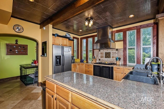 204 7th Ave N, Twin Falls, ID 83301 - kitchen with stainless steel fridge, wall chimney exhaust hood, a sink, light brown cabinets, and beam ceiling